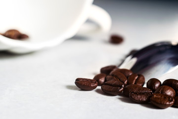 Coffee beans and a white Cup