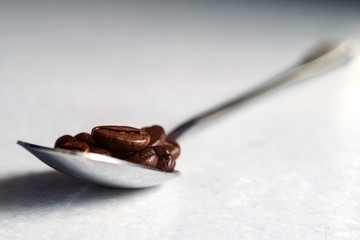Coffee beans and a white Cup