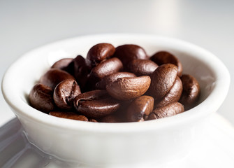 Coffee beans and a white Cup
