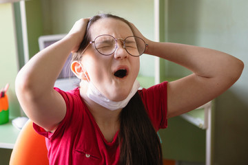 Teenager girl in a protective medical mask and glasses.