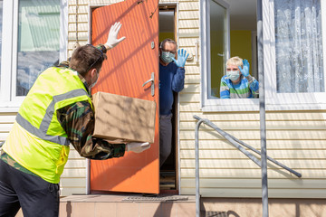 coronavirus pandemic. Epidemic. A volunteer / soldier brought food for senior citizens