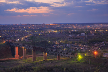 Bridge over the river against the background of the evening city
