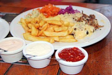 Seasonings for dinner. Fried potatoes with sauces in restaurant