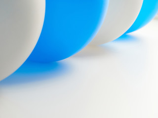 Close-up background, gray and blue balls lie on a white surface.
