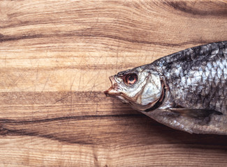 Dried fish on a wooden plate.
