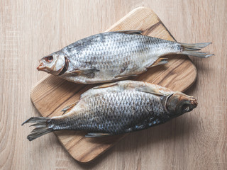 Dried fish on the table. Salty dry river fish on a wooden background.