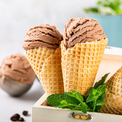Delicious summer dessert coffee ice cream in waffle cone. Summertime healthy food concept, lactose free. Copy space.