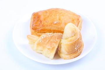 Fresh and tasty croissant on white background