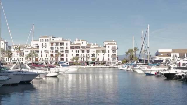 MANILVA, MALAGA / Spain - December 14 2019: Beautiful panoramic view of "Puerto de la Duquesa" Yachts and boats docked in the Harbour. Luxury Apartment Urbanisation and Restaurants. No camera movement