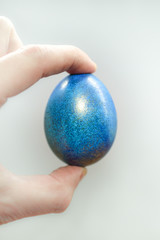 blue easter egg in hand