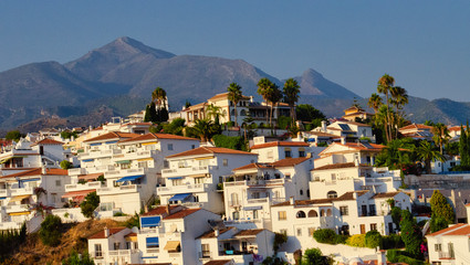 Sunset in the white village of Nerja in Malaga, Andalusia, Spain.  Mountains, hills in the background.