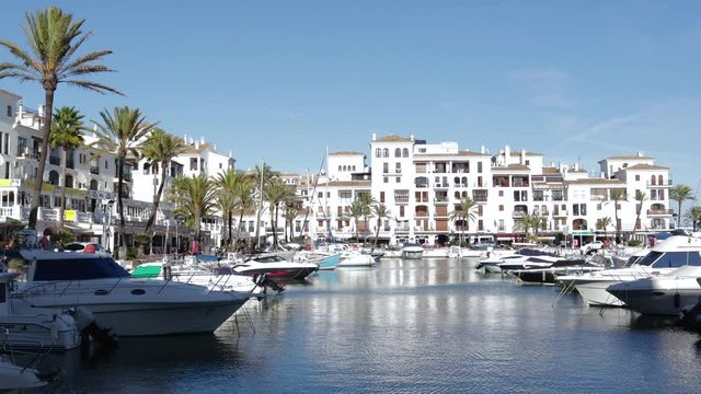 MANILVA, MALAGA / Spain - December 14 2019: Beautiful panoramic view of "Puerto de la Duquesa" Yachts and boats docked in the Harbour. Luxury Apartment Urbanisation and Restaurants. No camera movement