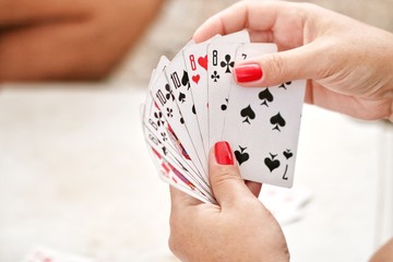 female hands hold playing cards