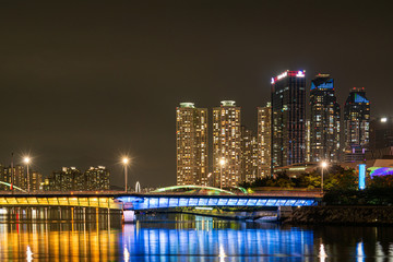 Fototapeta na wymiar The skyscraper and the night view of the city in Haeundae, Busan, South Korea