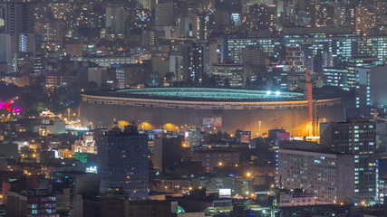 Fototapeta na wymiar Aerial view of the National stadium in the Peruvian capital Lima from San Cristobal hill night timelapse