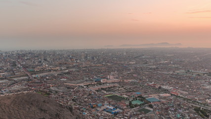 Fototapeta na wymiar Aerial view of Lima skyline day to night timelapse from San Cristobal hill.