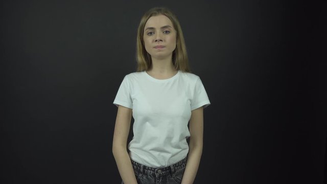 sad lady in white t-shirt breathes deeply and looks straight