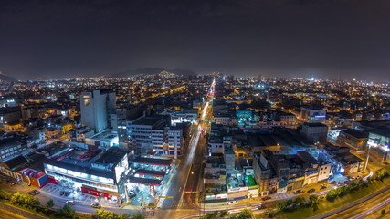 Fototapeta na wymiar Panoramic skyline of Lima city from above with many buildings aerial night timelapse. Lima, Peru