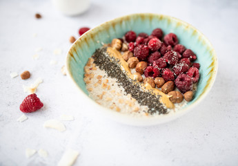 Oatmeal with raspberries, hazelnut and chia seeds.