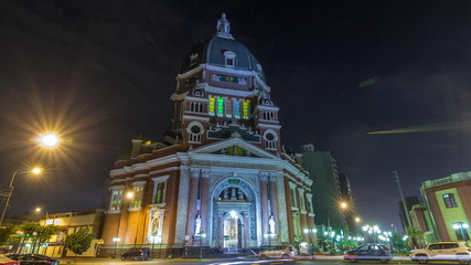 Fototapeta na wymiar Exterior of the Immaculate Heart of Mary Church illuminated at night timelapse hyperlapse. Lima, Peru