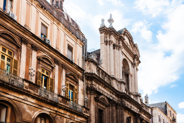 Traditional architecture of Sicily in Italy, typical street of Catania, facade of old building church cathedral.