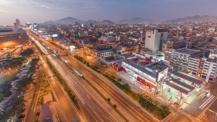 Fototapeta na wymiar Aerial view of Via Expresa highway and metropolitan bus with traffic day to night timelapse. Lima, Peru
