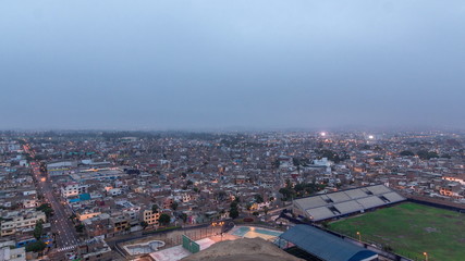 Naklejka premium Panoramic skyline of Lima city from above with many buildings aerial night to day transition timelapse. Lima, Peru