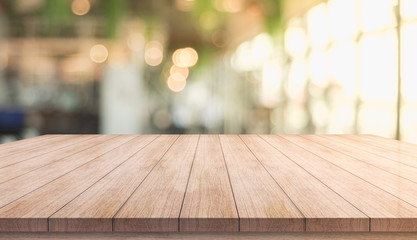 Wooden top table with bokeh light effect and blur restaurant on background, blur background