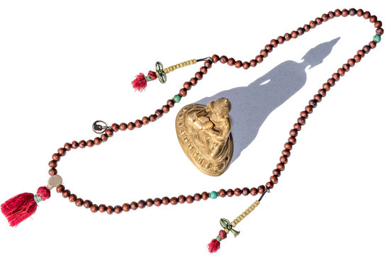 Antique Tibetan Buddhist Prayer Beads on White Background with Brass Buddha