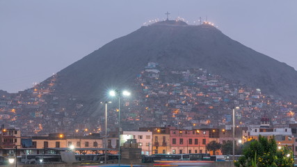 Slums on the slope of hill San Cristobal on the northern side of the river Rimac day to night timelapse. Lima, Peru