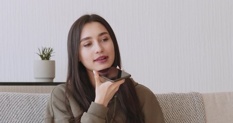 Young girl using voice recognition on phone to record message