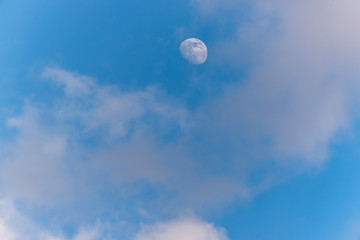 Three Quarter Moon in a Blue Sky with Clouds