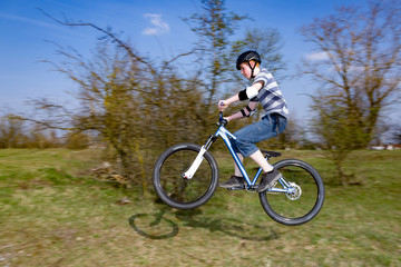 Fototapeta na wymiar boy jumping with his dirt bike