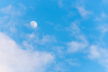 Three Quarter Moon in a Blue Sky with Clouds