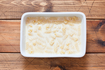 Step-by-step preparation of pasta casserole with eggs, step 4 - ceramic pasta in a ceramic form...