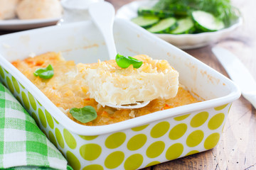 Ceramic pasta casserole with egg, selective focus