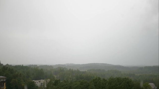 Aerial panoramic time lapse of green valley and sky with clouds flying over the green forest. Summer rain . View from the top of the hill in 4k
