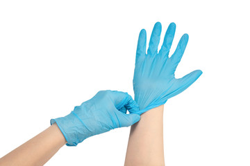 Woman puts on blue rubber gloves.