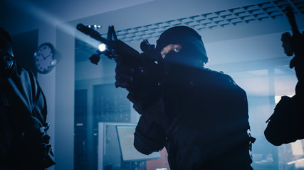 Masked Team of Armed SWAT Police Officers Move in a Hall of a Dark Seized Office Building with...