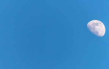 Three Quarter Moon in a Blue Sky