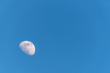 Three Quarter Moon in a Blue Sky