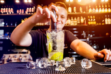 Bartender is making cocktail at bar counter. Fresh cocktails. Barman 