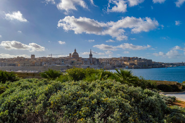 Fototapeta na wymiar Panoramic view of Valletta Skyline at beautiful sunset from Sliema with churches