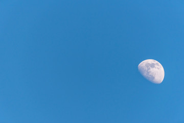 Three Quarter Moon in a Blue Sky