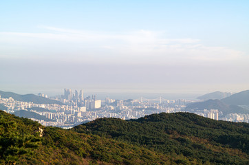 The view of Haeundae area and the sea from the top of the famous mountain in Busan, Korea