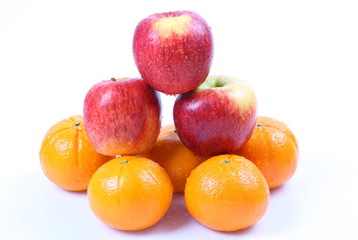 Orange fruit and red apple on white background