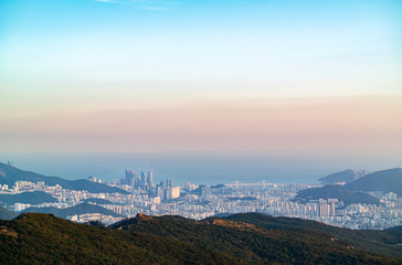 Fototapeta premium The view of Haeundae area and the sea from the top of the famous mountain in Busan, Korea
