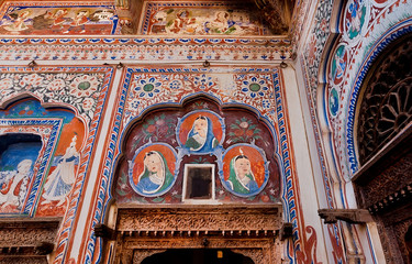 Portraits of rich women on walls, colorful fresco of the old house in Shekhawati region