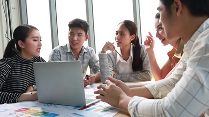 Group of asian young modern people in smart casual wear having a brainstorm meeting while sitting in office background. Business meeting, Planning, Strategy, New business development, Startup concept. - Powered by Adobe