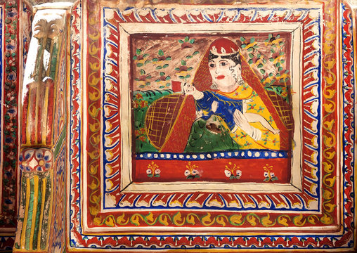 Naive portrait of mother with child on wall, fresco of the old house in Shekhawati region